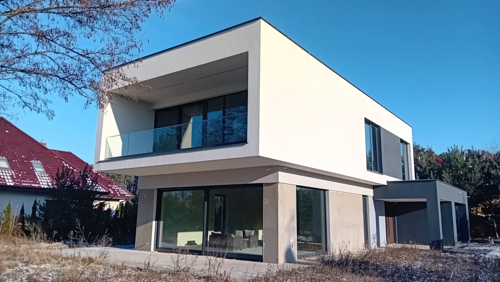 Energy-efficient two-story house with flat roof and garage